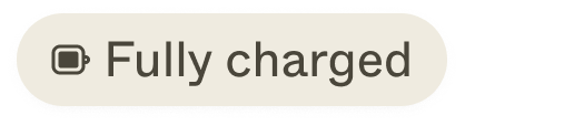 A light gray charging status pill with an icon (full battery symbol) and a label ("fully charged")